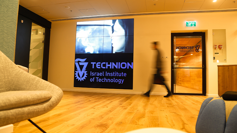 Student walking past an Omega Video Wall powered by Atlona at the Technion